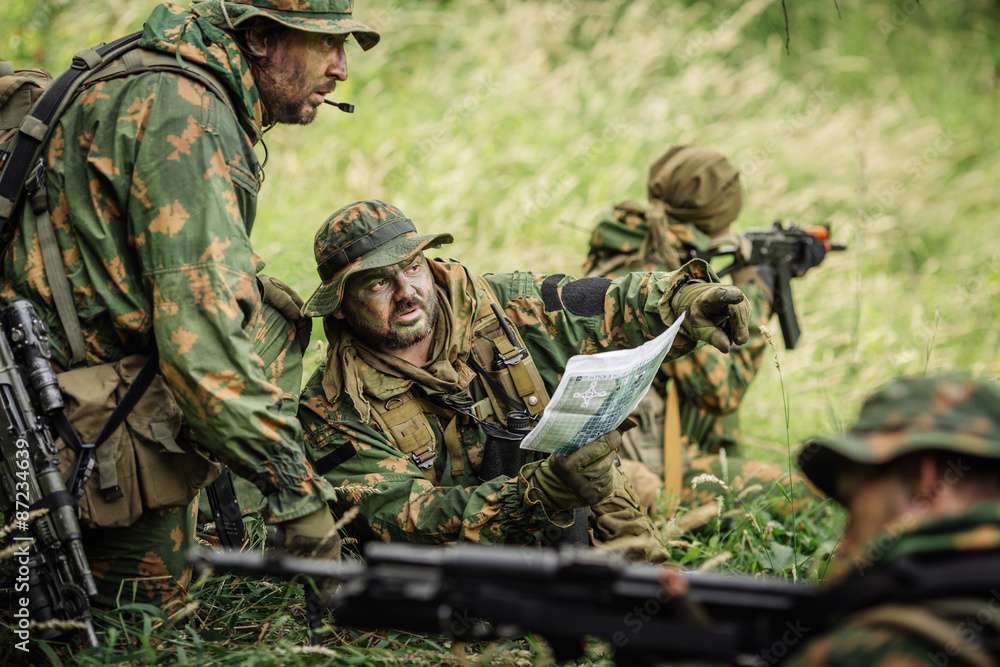 Ranger commander explains the combat mission and points to a map Ranger commander explains the combat mission and points to a map