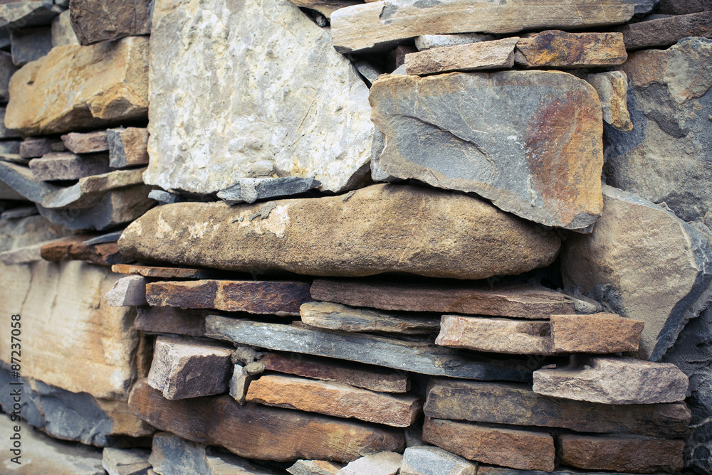 Close view of a rough mediterranean stone wall as background. Close view of a rough mediterranean stone wall as background.