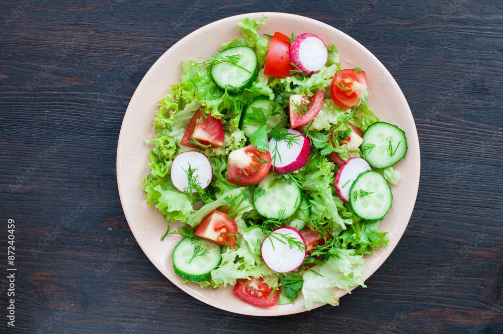 Tomato and cucumber salad with lettuce leafes