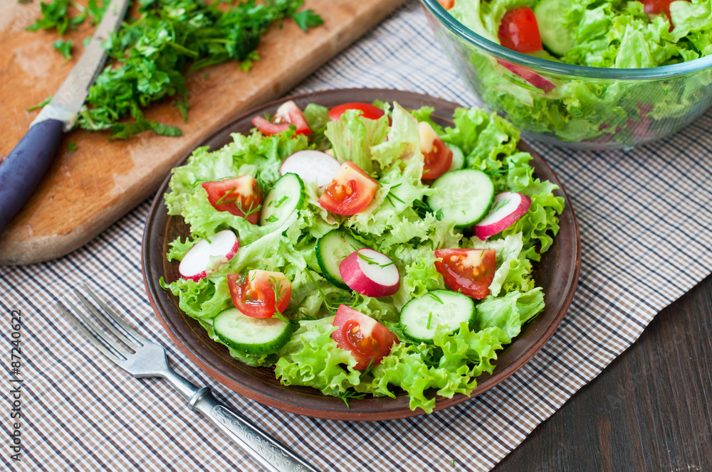 Tomato and cucumber salad with lettuce leafes Tomato and cucumber salad with lettuce leafes