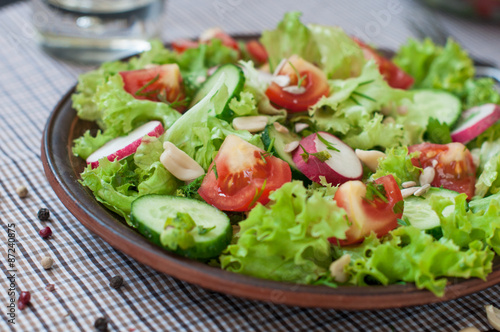 Tomato and cucumber salad with lettuce leafes