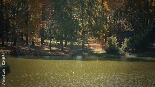 Slow motion stock clip of man firing a shotgun at a clay pigeon.  