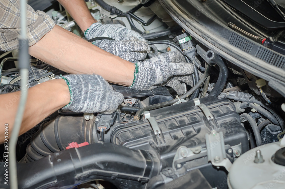 Auto mechanics repairing a car LPG system. Auto mechanics repairing a car LPG system.
