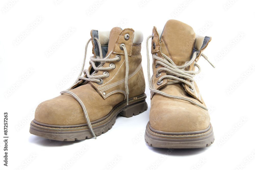A pair of work boots isolated on a white background. A pair of work boots isolated on a white background.