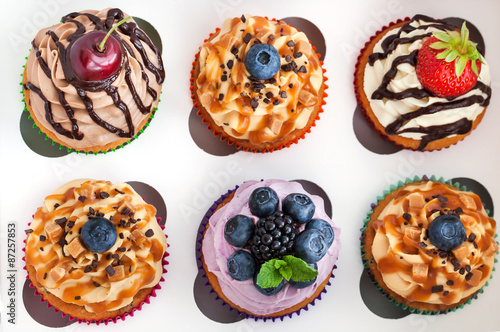 Set of different delicious cupcakes in box