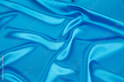 Soft folds of light blue silk cloth.