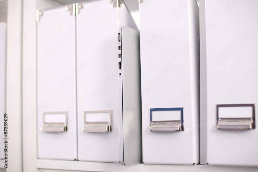 File folders, standing on shelves in the background File folders, standing on shelves in the background