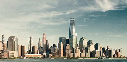 New York City lower Manhattan financial wall street district buildings skyline on a beautiful summer day filtered instagraam vintage desaturated looks