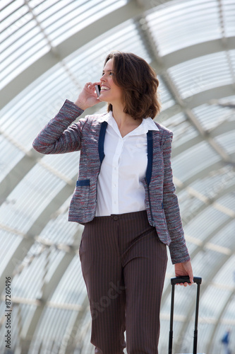 Business woman walking and talking on mobile phone