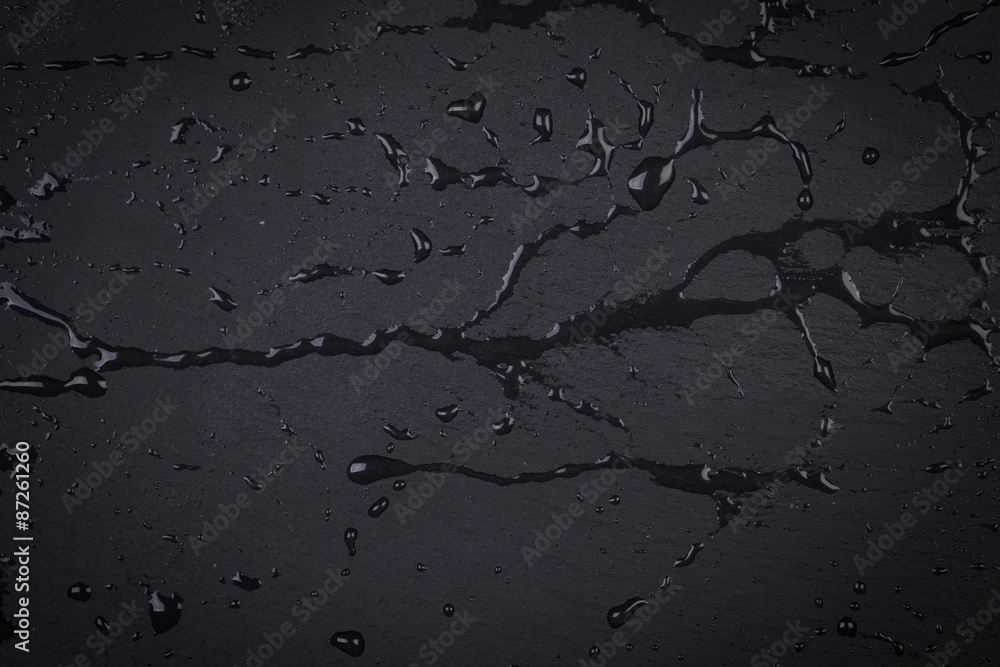 Fototapeta premium Water on dark stone surface