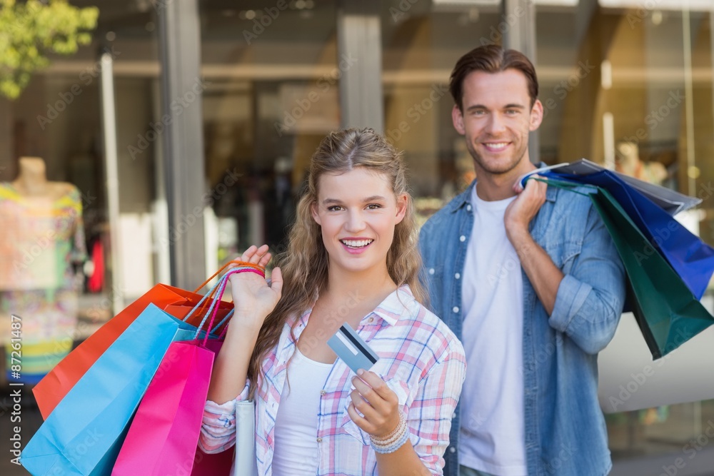 Portrait of a happy couple showing their new credit card Portrait of a happy couple showing their new credit card