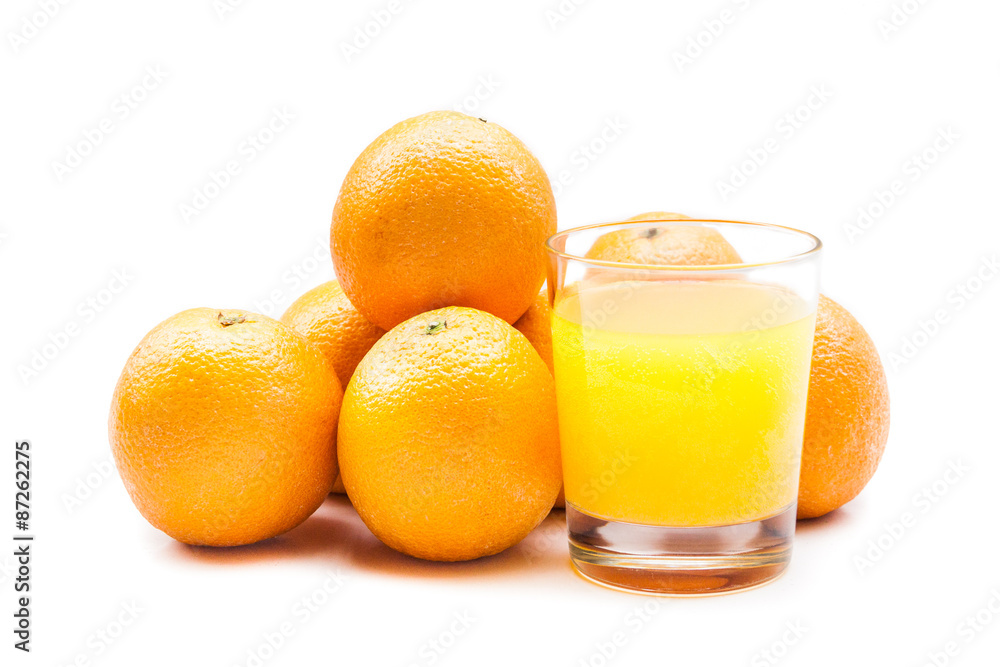Fizzy orange juice from effervescent tablet with oranges at backdrop Fizzy orange juice from effervescent tablet with oranges at backdrop