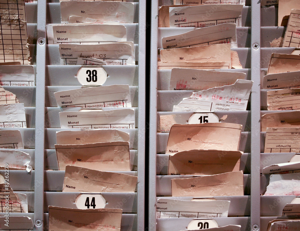 Factory Time Cards. A rack of time cards used by factory workers in ...
