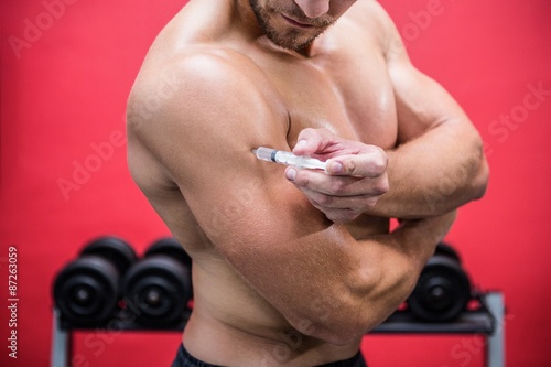 Slika na platnu Muscular man injecting steroids