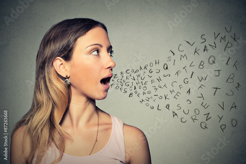 Woman talking with alphabet letters coming out of her mouth photo