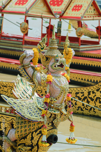 Thai garuda in front of the royal march boat on the river