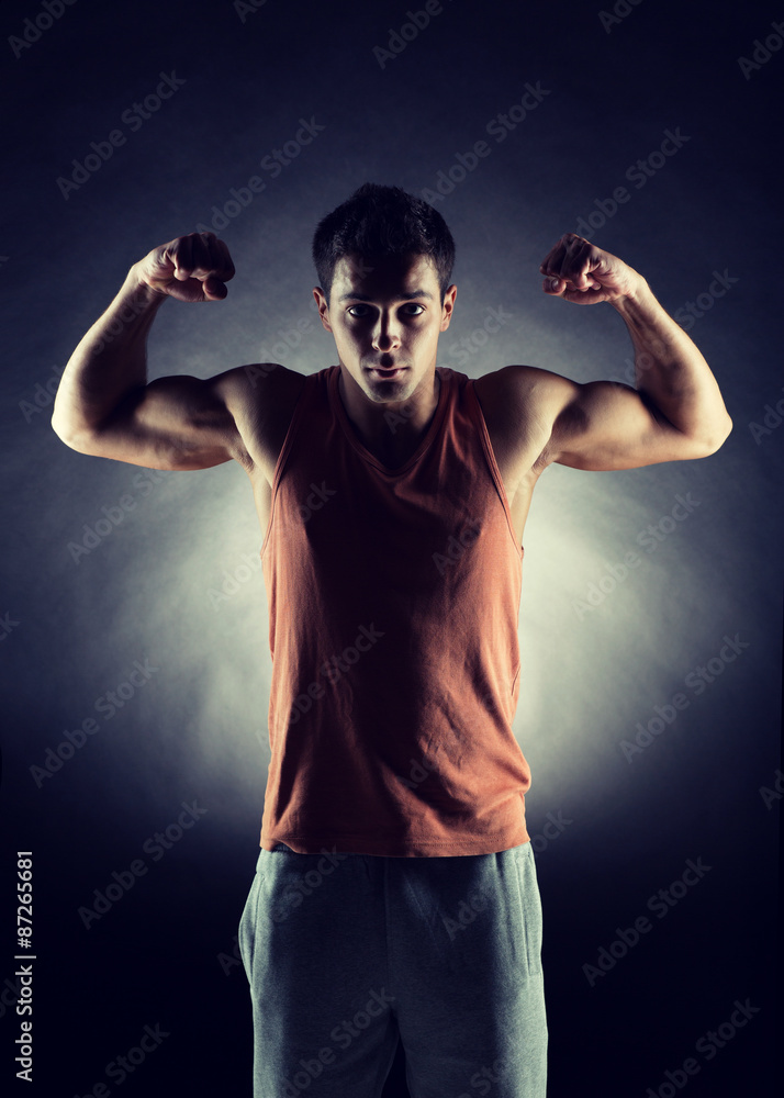 young man showing biceps young man showing biceps