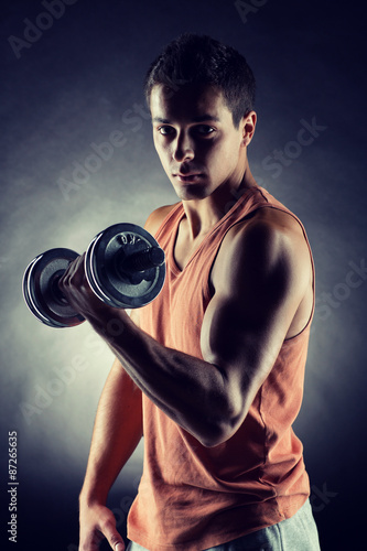 young man with dumbbell © Syda Productions