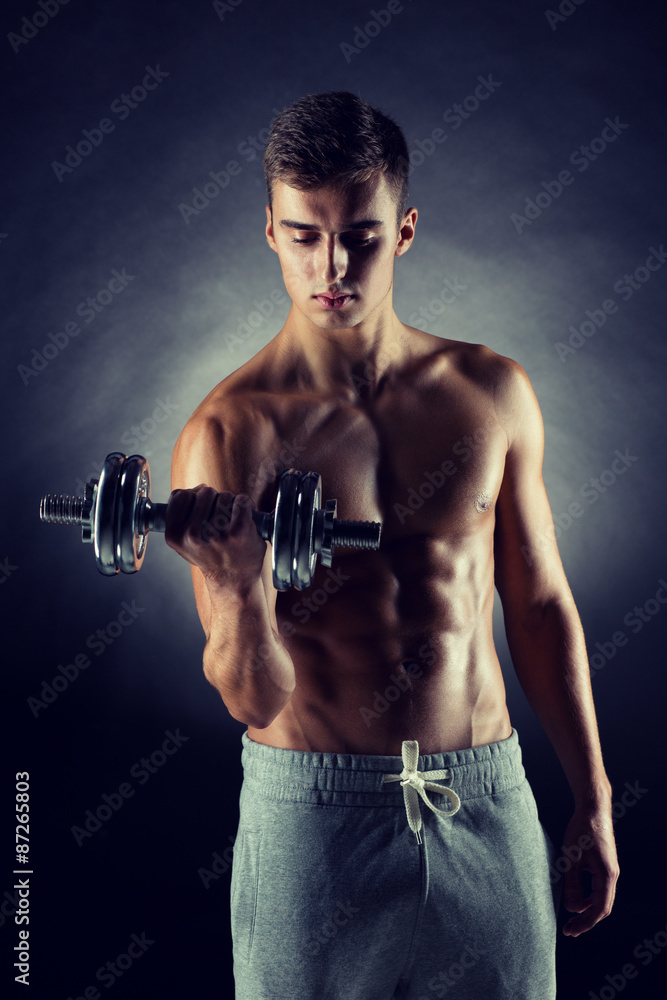 young man with dumbbell young man with dumbbell