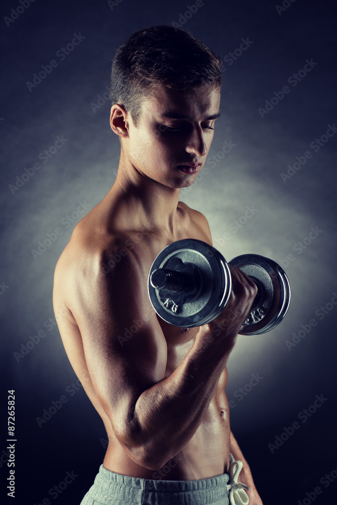 young man with dumbbell young man with dumbbell