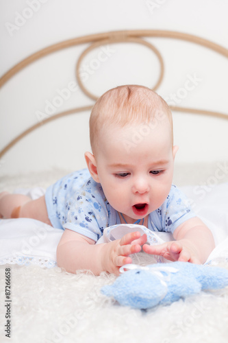 Nice little boy  plaing with soft toy photo