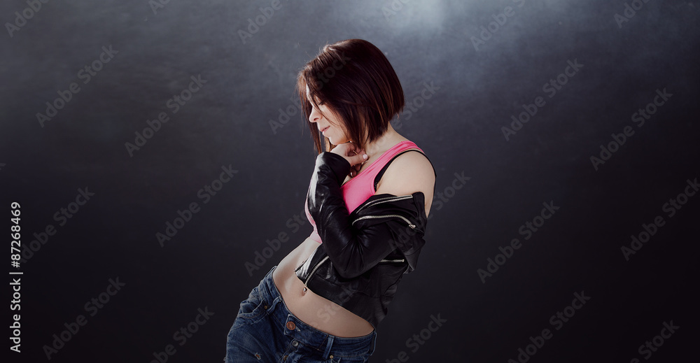 young woman hip hop dancer on the background texture dark wall young woman hip hop dancer on the background texture dark wall