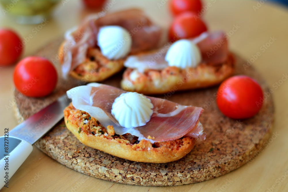 Italian Bruschetta With Mozzarella And Prosciutto On A Wooden Table Italian Bruschetta With Mozzarella And Prosciutto On A Wooden Table
