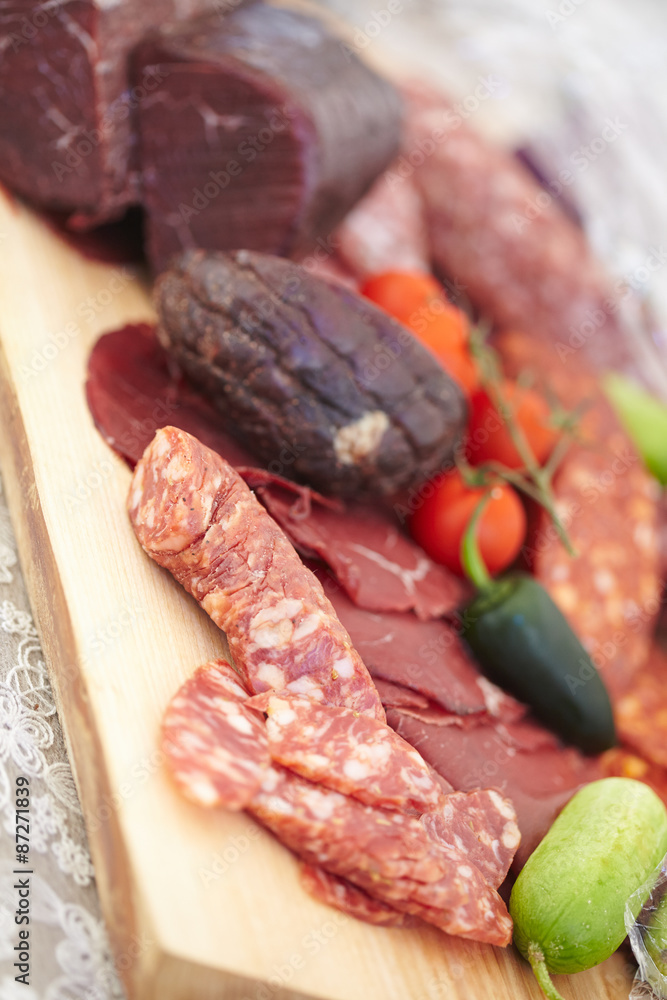 smoked meat products, vegetables on the table smoked meat products, vegetables on the table