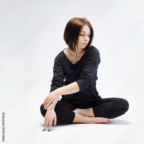  young beautiful woman sitting in lotus position, closeup