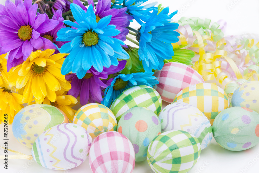 Easter Flowers and Eggs – Brightly colored daisies with decorated eggs for Easter.