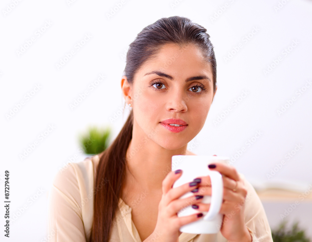 Beautiful businesswoman enjoying coffee in bright office Beautiful businesswoman enjoying coffee in bright office