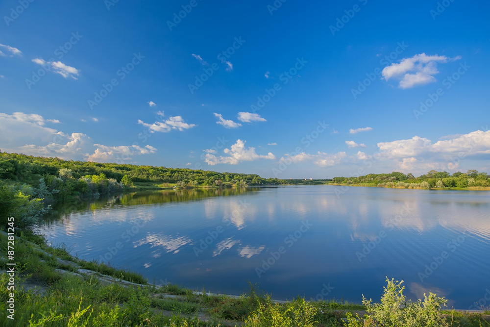 Calm beautiful rural landscape with a lake 