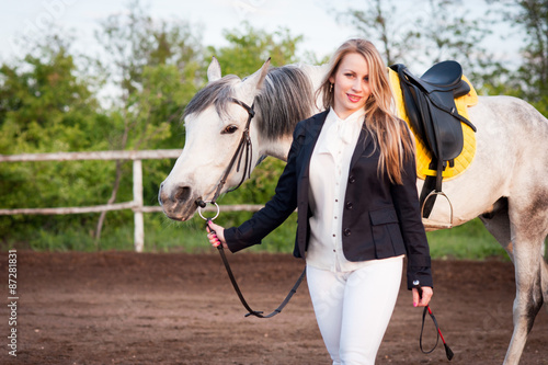 Horsewoman at hippodrome and blue sky