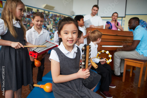 Group Of Children Playing In School Orchestra Together