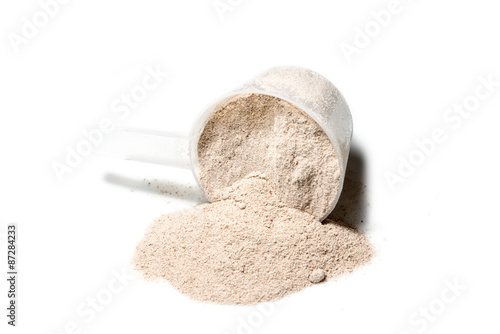 Scoop of Isolate protein powder chocolate deluxe flavour  poured