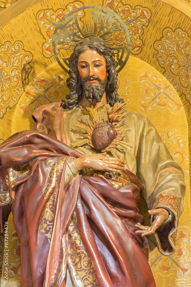 GRANADA, SPAIN - MAY 29, 2015: The the carved statue of The Heard of Jesus in church Nuestra Senora de las Angustias by Josr de Mora (17. cent.).