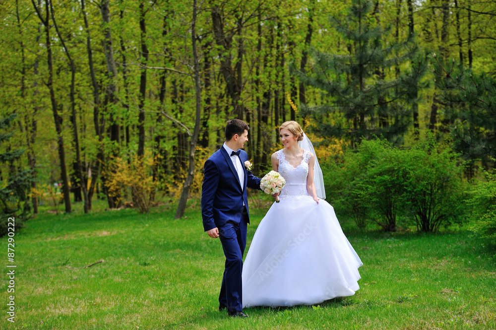 Bride and groom walking on the spring park Bride and groom walking on the spring park