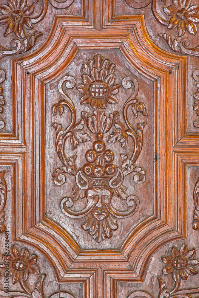 GRANADA, SPAIN - MAY 29, 2015: The detail of carved baroque door of Basilica San Juan de Dios.