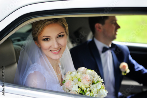 Portrait of bride groom in car window