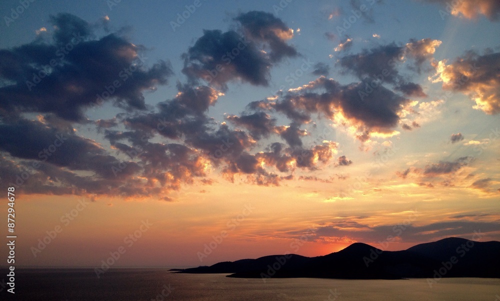 bright sunset over seaside mountains
