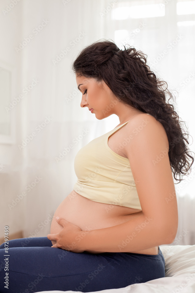 Cute young pregnant woman is having rest
