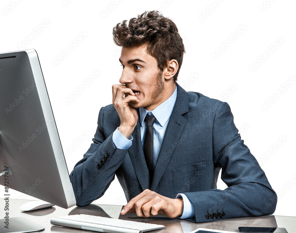 Employer looking at computer screen with horror Employer looking at computer screen with horror