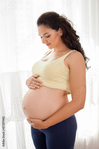 Pretty young pregnant woman is preparing for childbirth