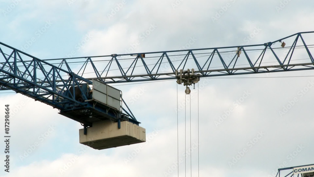Crane working on the construction site, close up process Crane working on the construction site, close up process