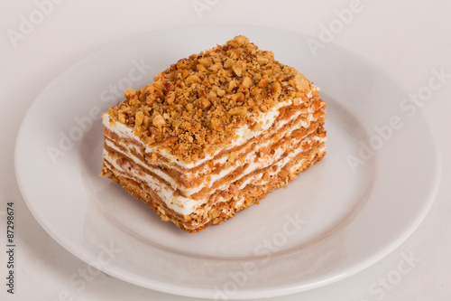 honey cake on a plate white background for cafe menu 