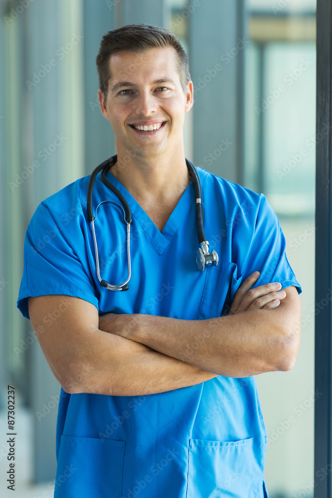 young medical intern standing in hospital young medical intern standing in hospital