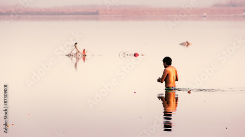 Indian man taking holy dip in The Ganga river