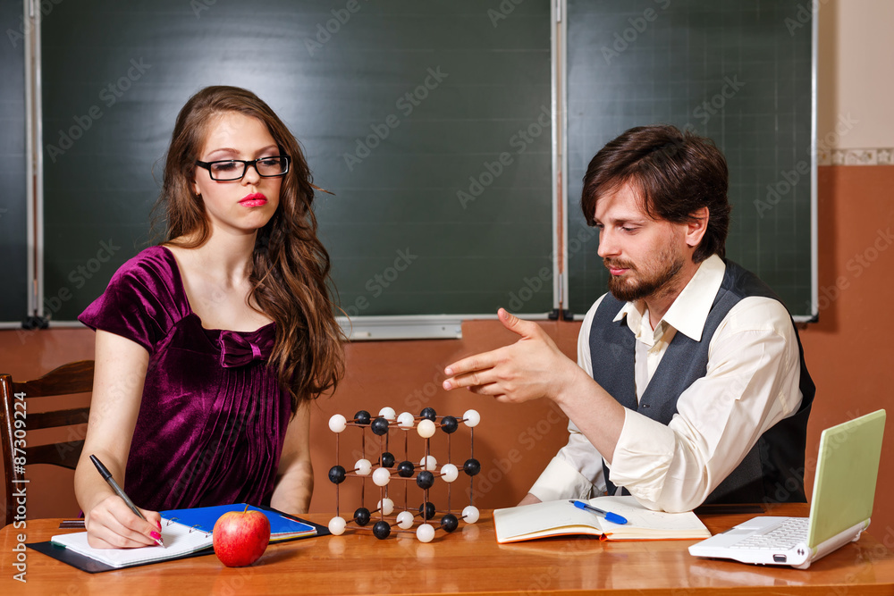 Fototapeta premium Teacher explains structure of crystal lattice of student.