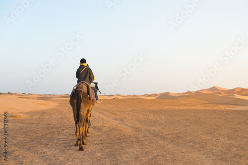 The asian tourist ride camel in Sahara desert