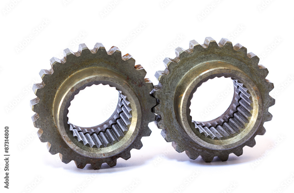 A dirty industrial gear isolated on a white background A dirty industrial gear isolated on a white background